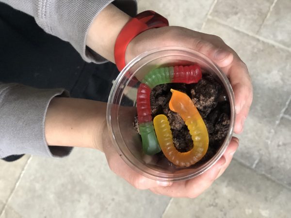 worm pudding cup in childs hands