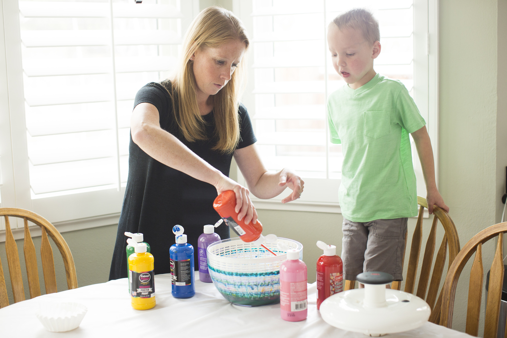 Gettting creative at home with the kids. Mom and preschooler doing spin art.